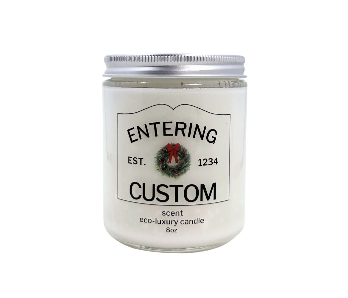 8oz Holiday “Entering Your Town” custom candle with festive wreath icon, personalized label, hand-poured in eco-friendly coconut wax