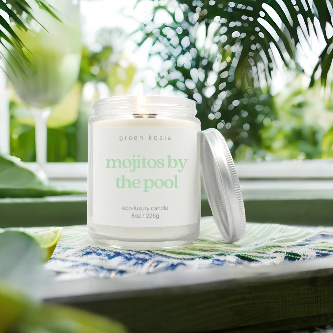 Mojito candle burning on a table outside by a pool.