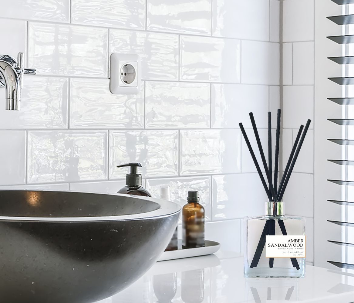 7oz reed diffuser in a square bottle with black reeds and in a bathroom setting