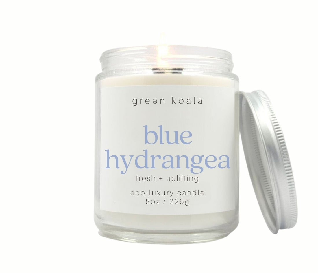 8oz Blue Hydrangea scented  non-toxic candle in aglass jar with a silver lid.