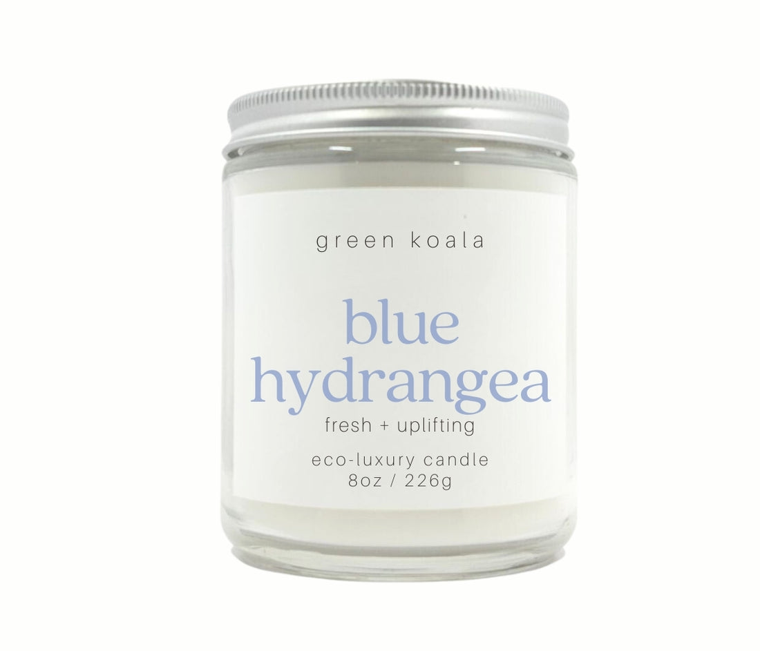 8oz Blue Hydrangea scented candle hand poured into a glass jar with a silver lid.