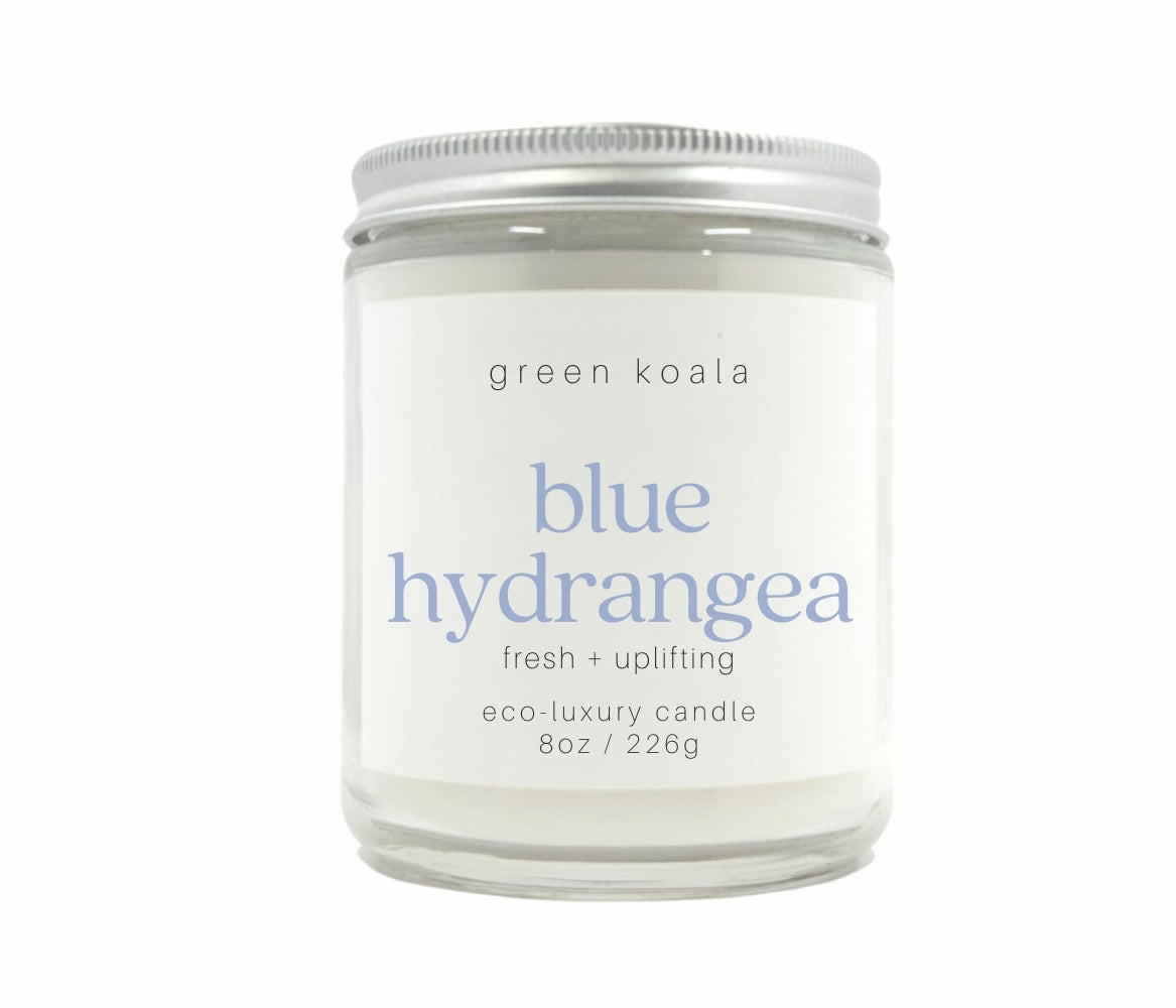 8oz Blue Hydrangea scented candle hand poured into a glass jar with a silver lid.