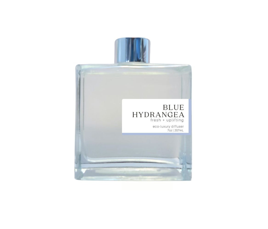 Glass bottle with silver cap filled with the delicate, floral fragrance of Blue Hydrangea for a soothing ambiance.