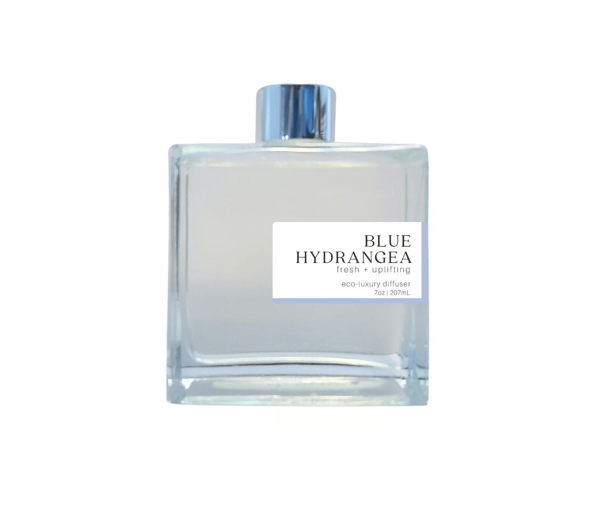 Glass bottle with silver cap filled with the delicate, floral fragrance of Blue Hydrangea for a soothing ambiance.