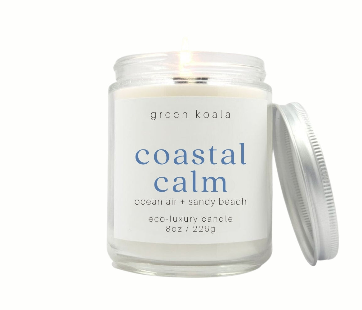8oz Coastal Calm scented non-toxic and clean burning candle in a glass jar with silver lid.
