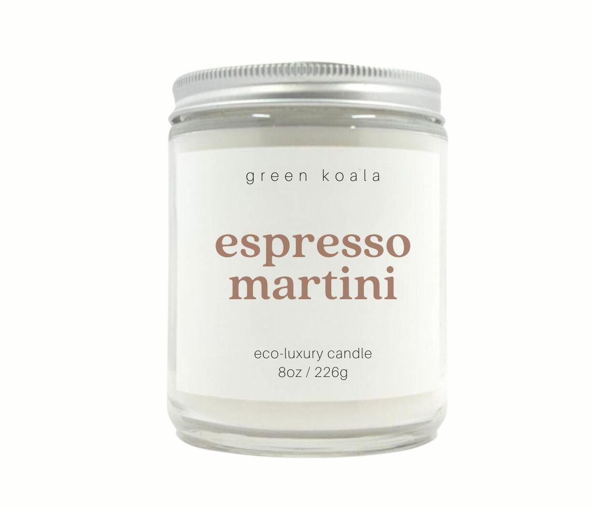 Espresso Martini scented 8 oz. candle featuring the words "espresso martini" in a light brown font. In this picture, a lid is present on top of the candle