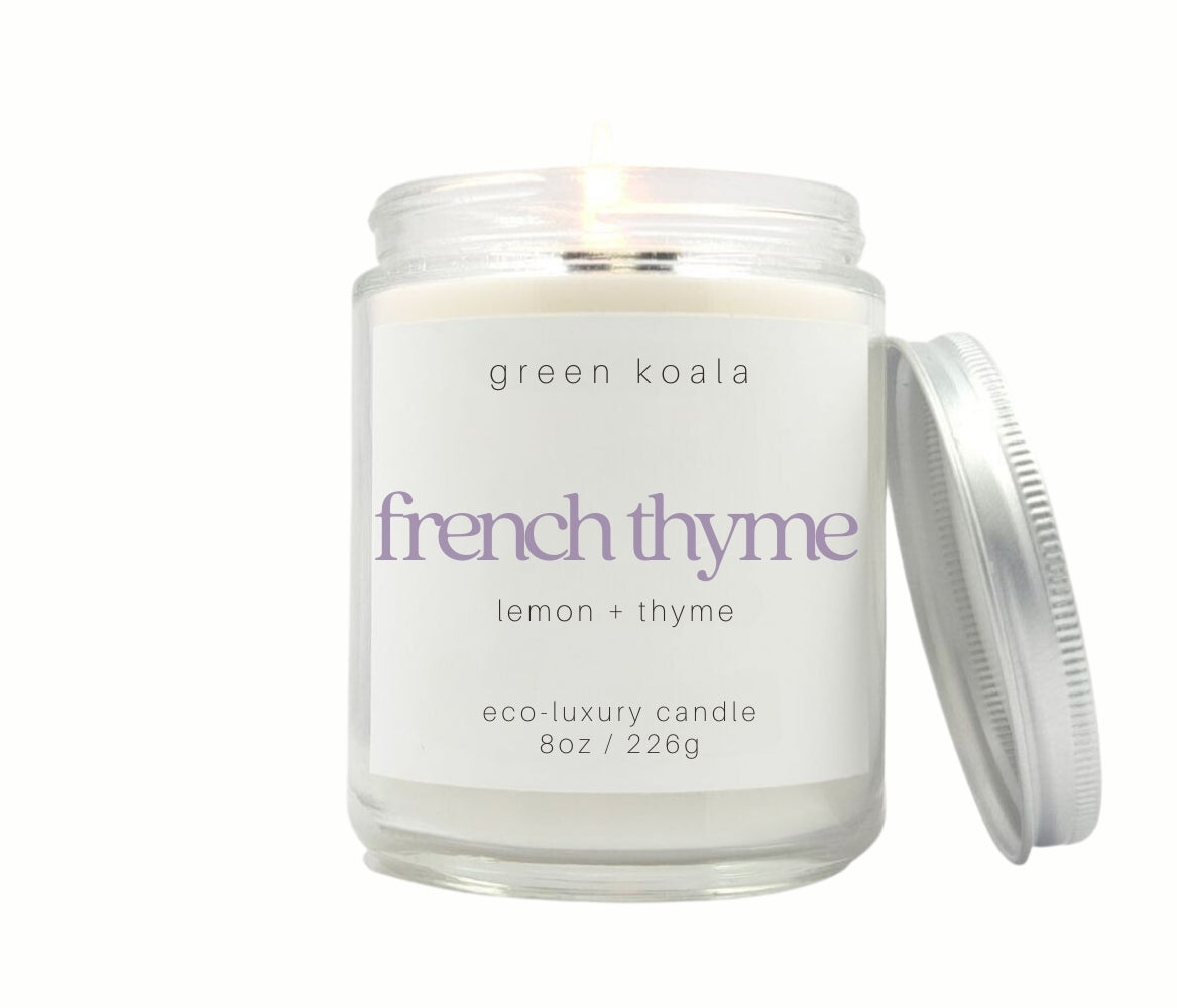 8oz French Thyme scented non-toxic and clean burning candle in a glass jar with silver lid.
