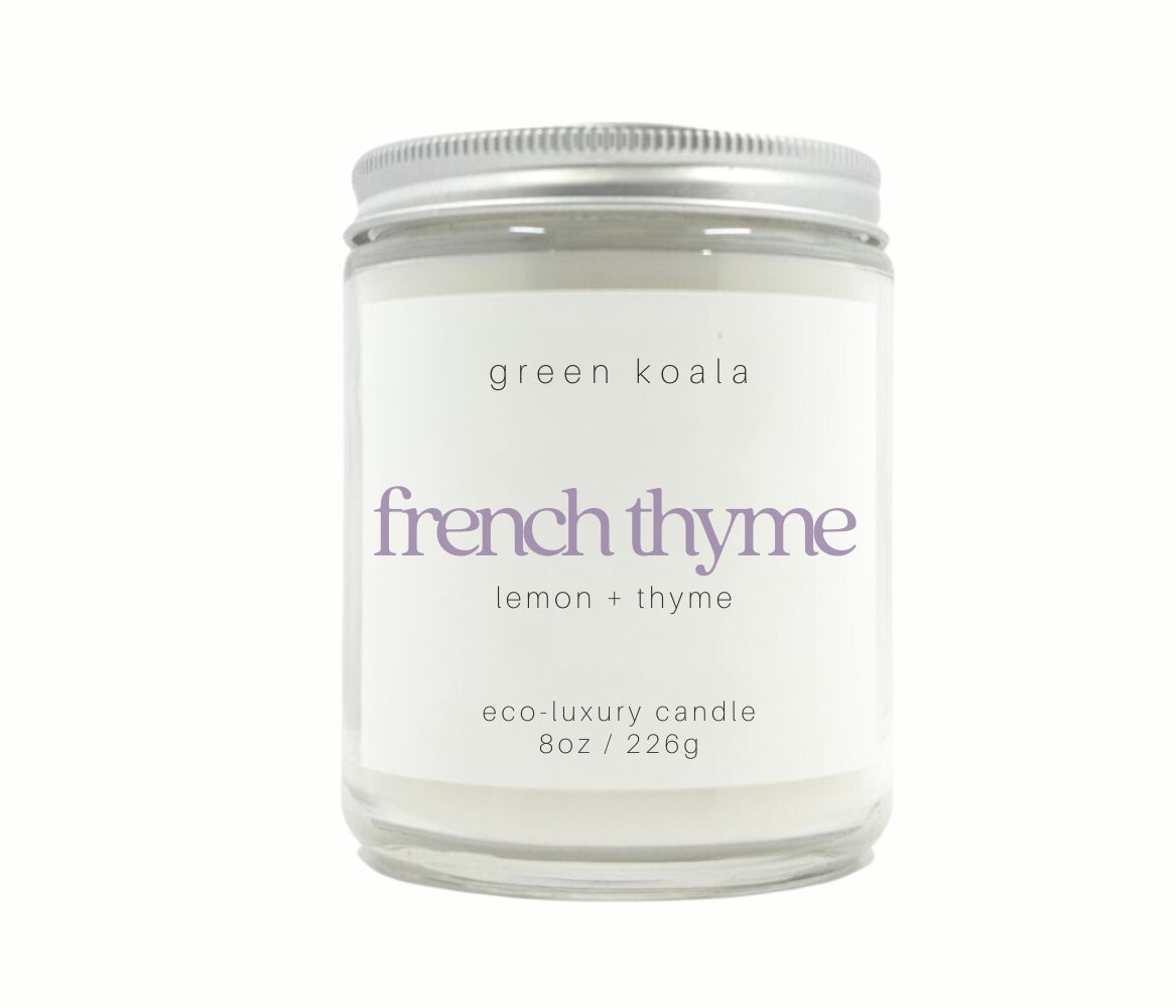 8oz French Thyme scented non-toxic hand poured candle in a glass jar with silver lid.