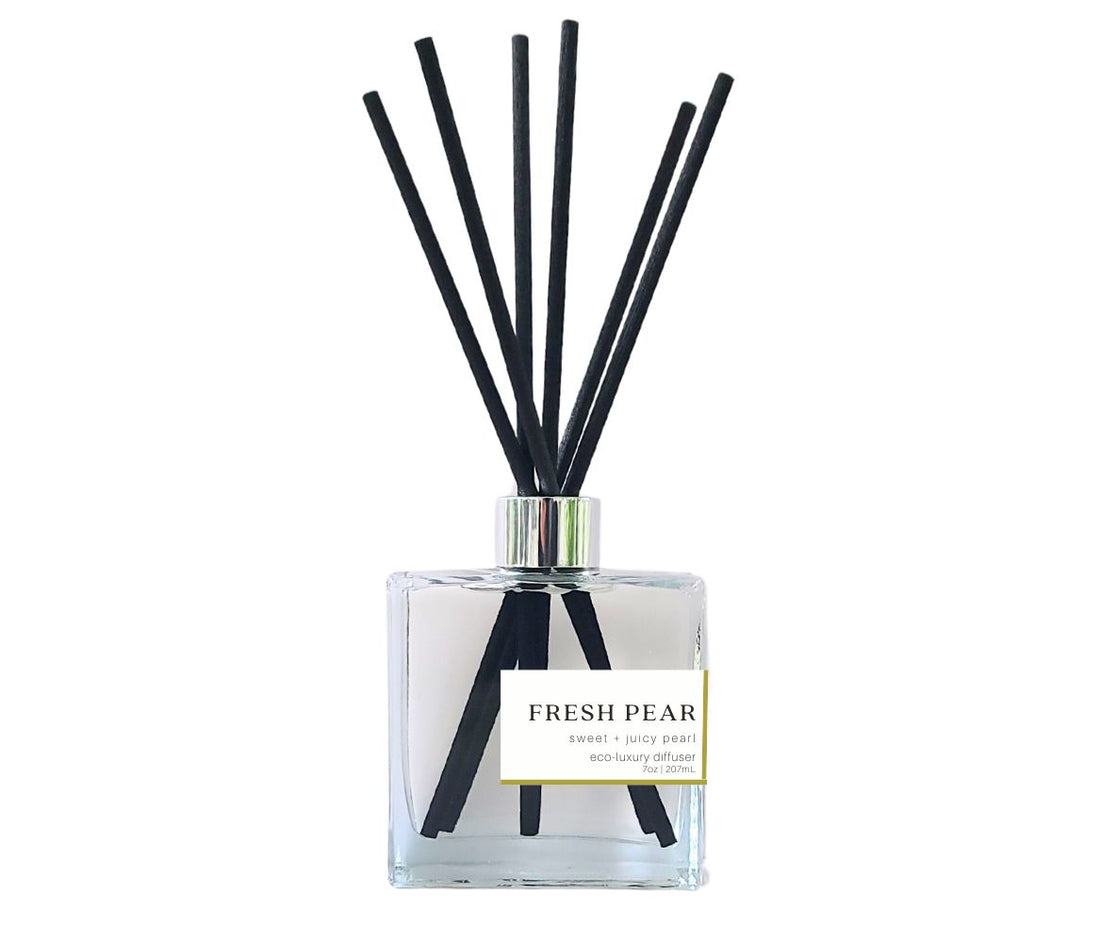 Fresh Pear reed diffuser with black reeds in a sleek glass bottle, releasing a fresh, non-toxic home fragrance.