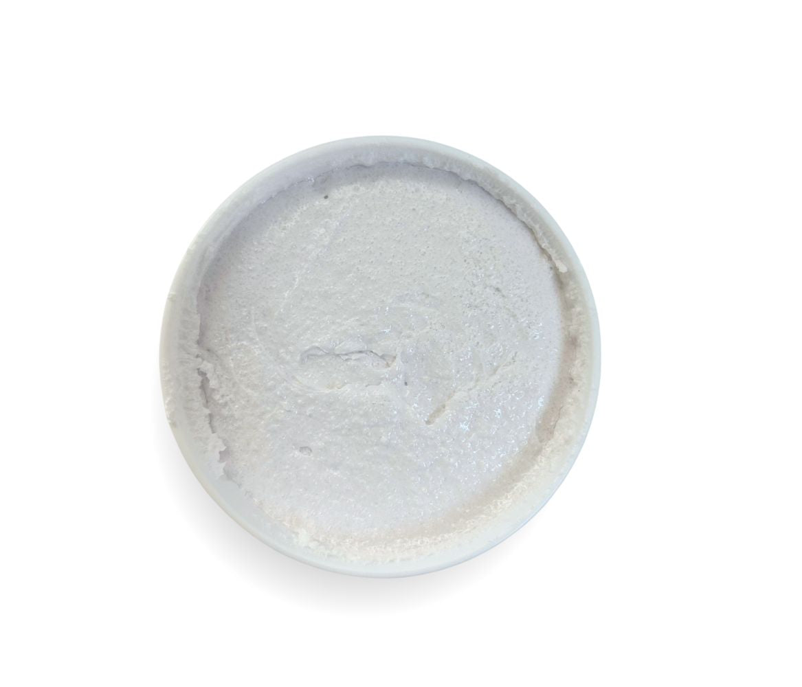 Top-down view of 9oz Lavender Sugar Body Scrub jar displaying whipped texture and calming floral scent, cleanses, exfoliates and hydrates skin.