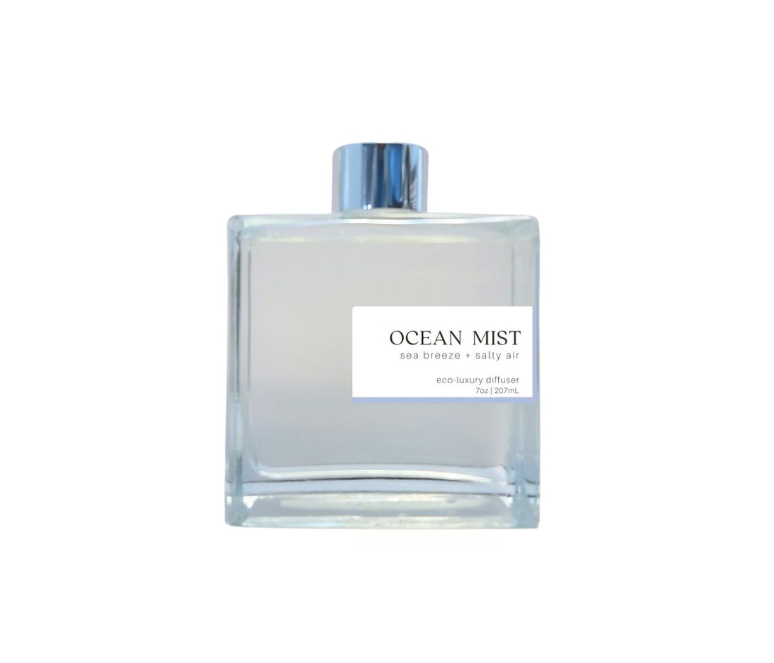 Glass diffuser bottle with silver cap, filled with ocean mist fragrance, evoking a calming, seaside atmosphere.
