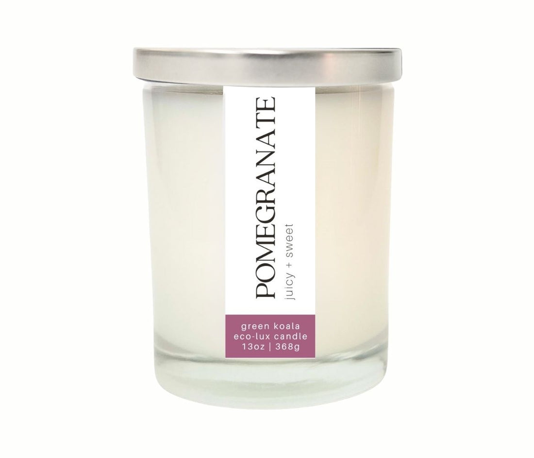 13oz Green Koala Pomegranate zero waste candle in a drinking glass with lid