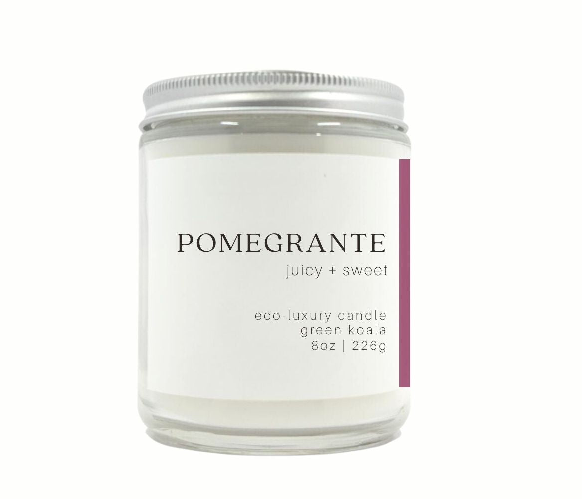 8oz Green Koala Pomegranate zero waste candle in a drinking glass with lid