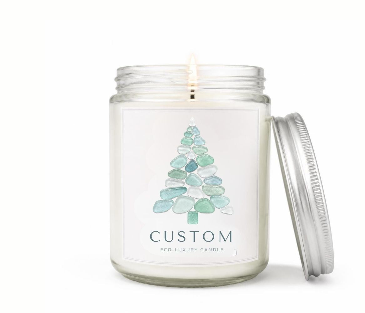 Green Koala personalized sea glass Christmas tree 8oz candle with custom coastal town name label, lit, with silver lid on a white background