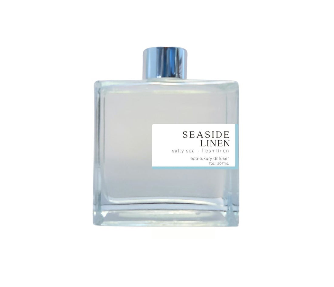Green Koala Seaside Linen reed diffuser in a stylish glass bottle with silver cap, evoking the scent of fresh linen and the sea.