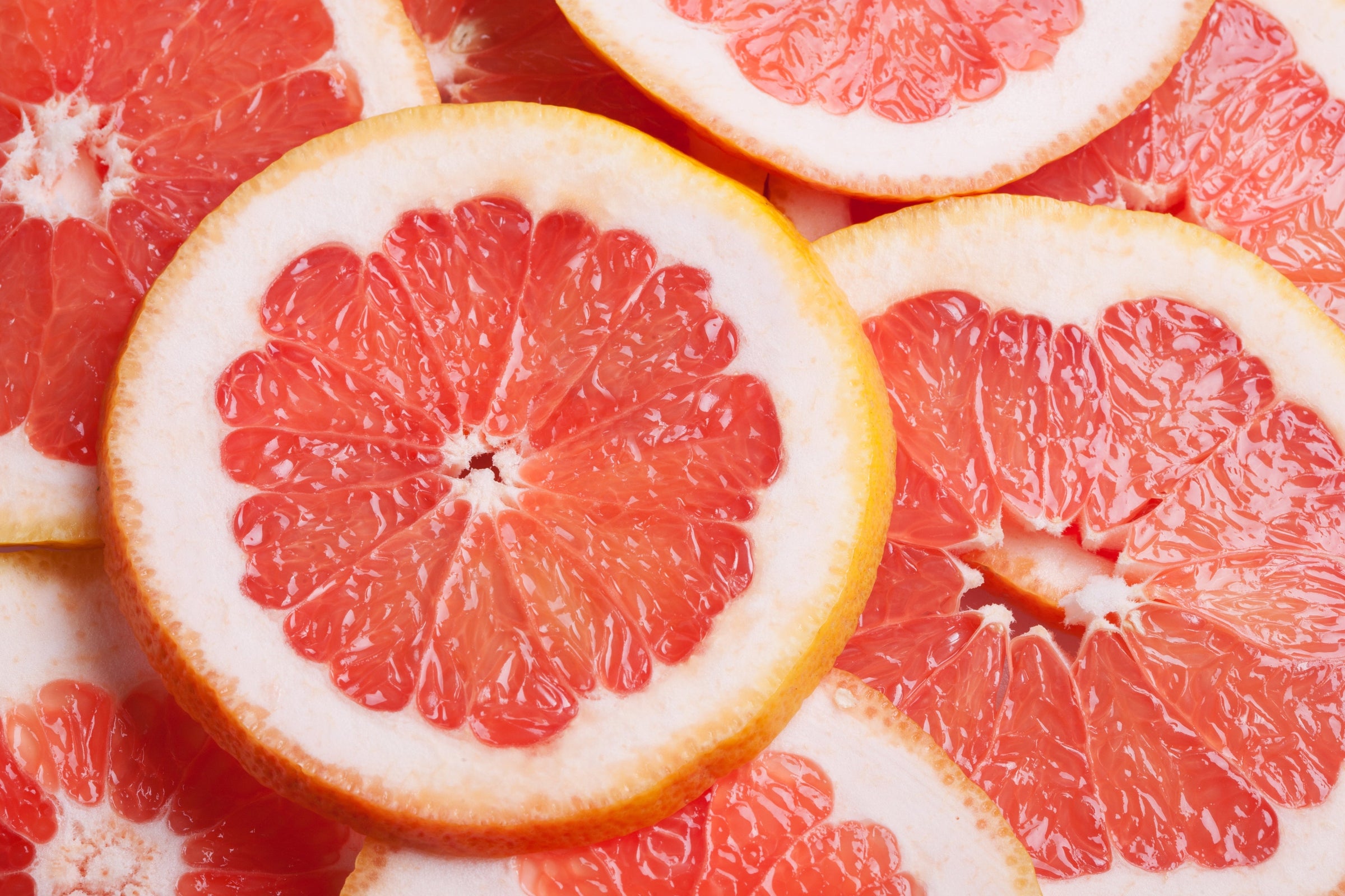Image of sliced pink grapefruits. 