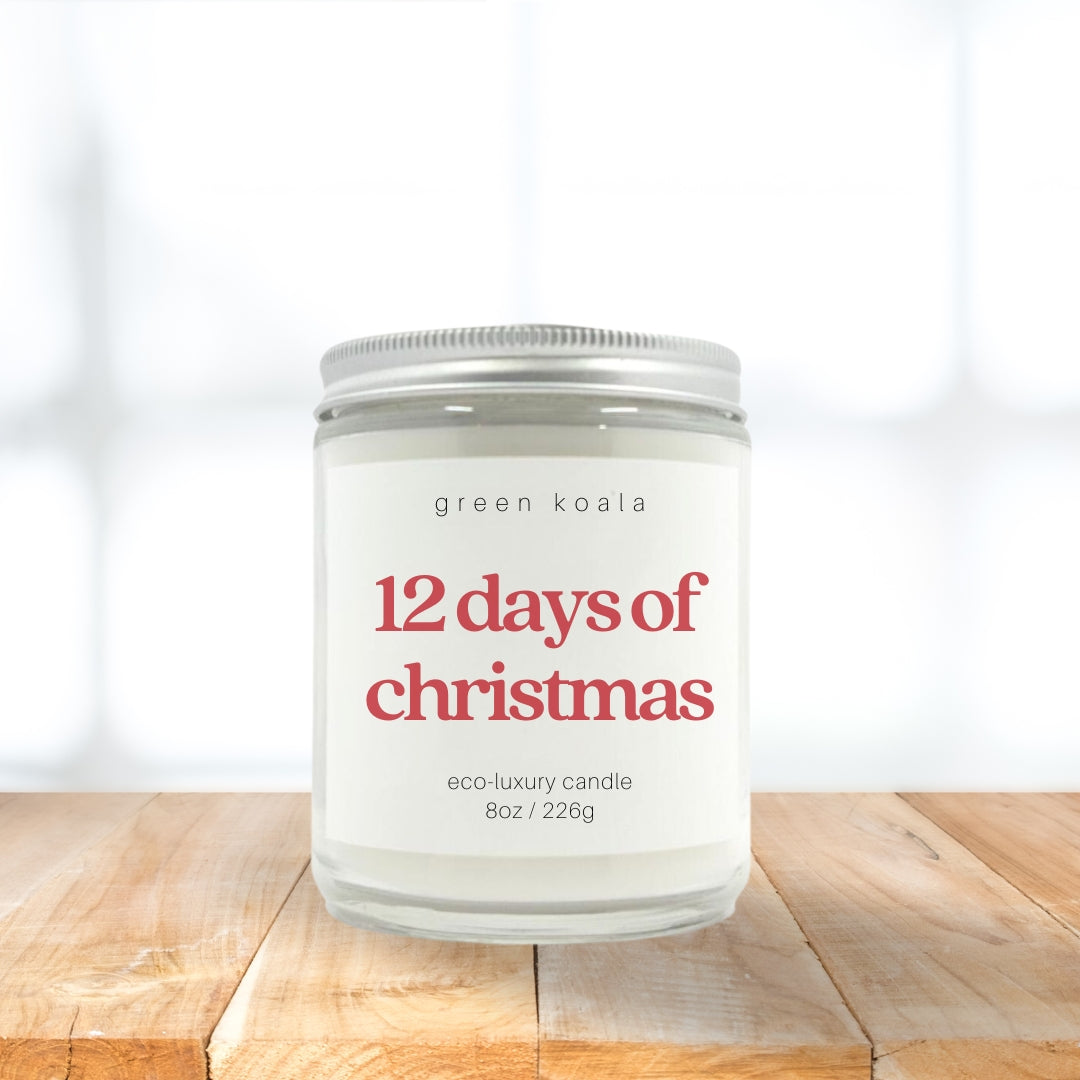 Image of 12 Days of Christmas candle in a glass jar with silver lid on a wooden shelf.  