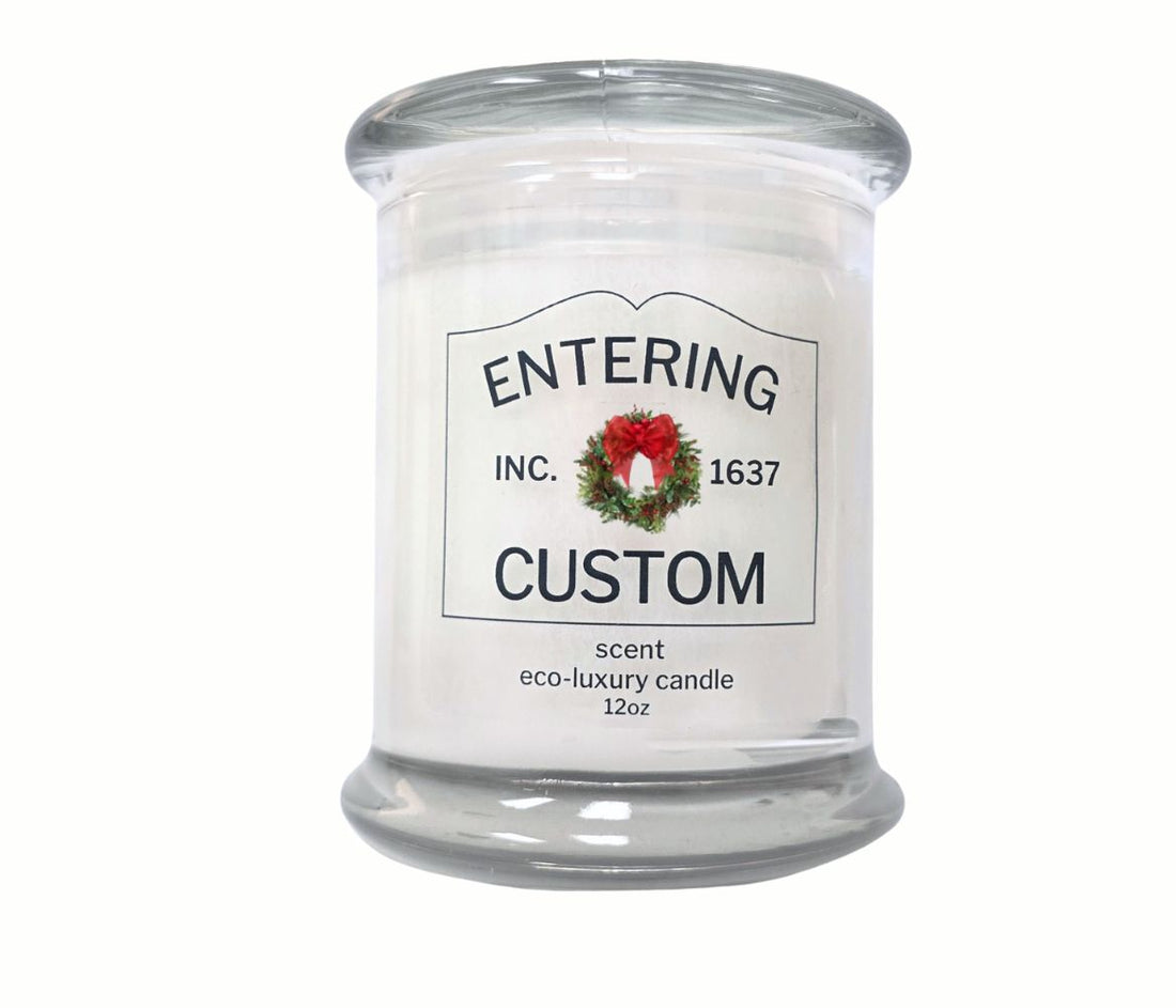 12oz Holiday “Entering Your Town” custom candle with wreath icon, personalized label, hand-poured in eco-friendly coconut wax