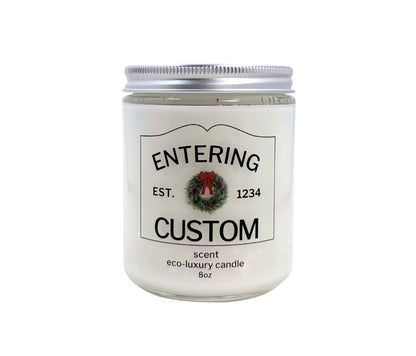 8oz Holiday “Entering Your Town” custom candle with festive wreath icon, personalized label, hand-poured in eco-friendly coconut wax