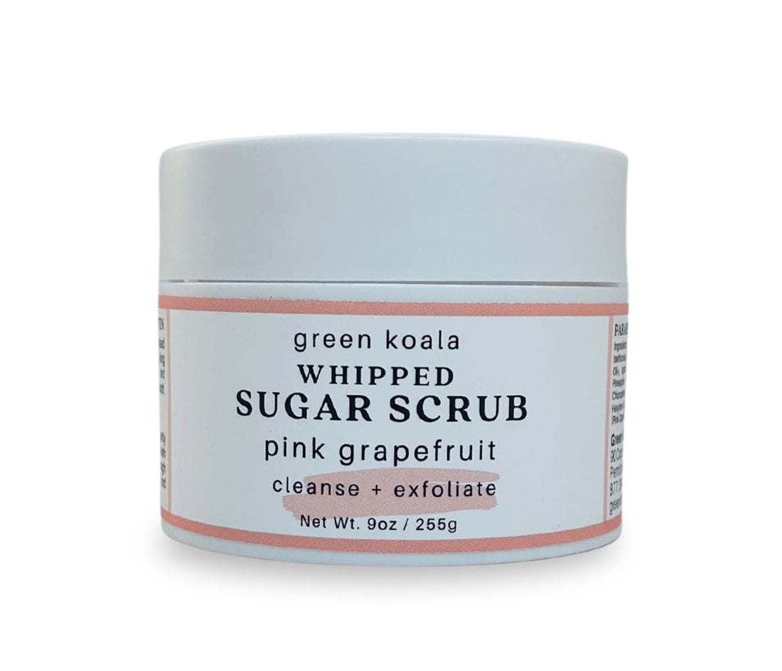 Front view of 9oz Pink Grapefruit Sugar Body Scrub jar with label, showcasing whipped texture and invigorating citrus scent, cleanses, exfoliates and hydrates skin.