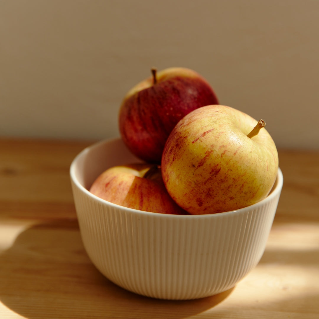 Honey-crisp apples in a bowl.