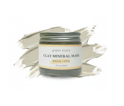 Jar of green koala clay mineral mask on a white background