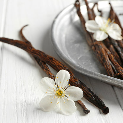 vanilla beans in a dish garnished with blossoms