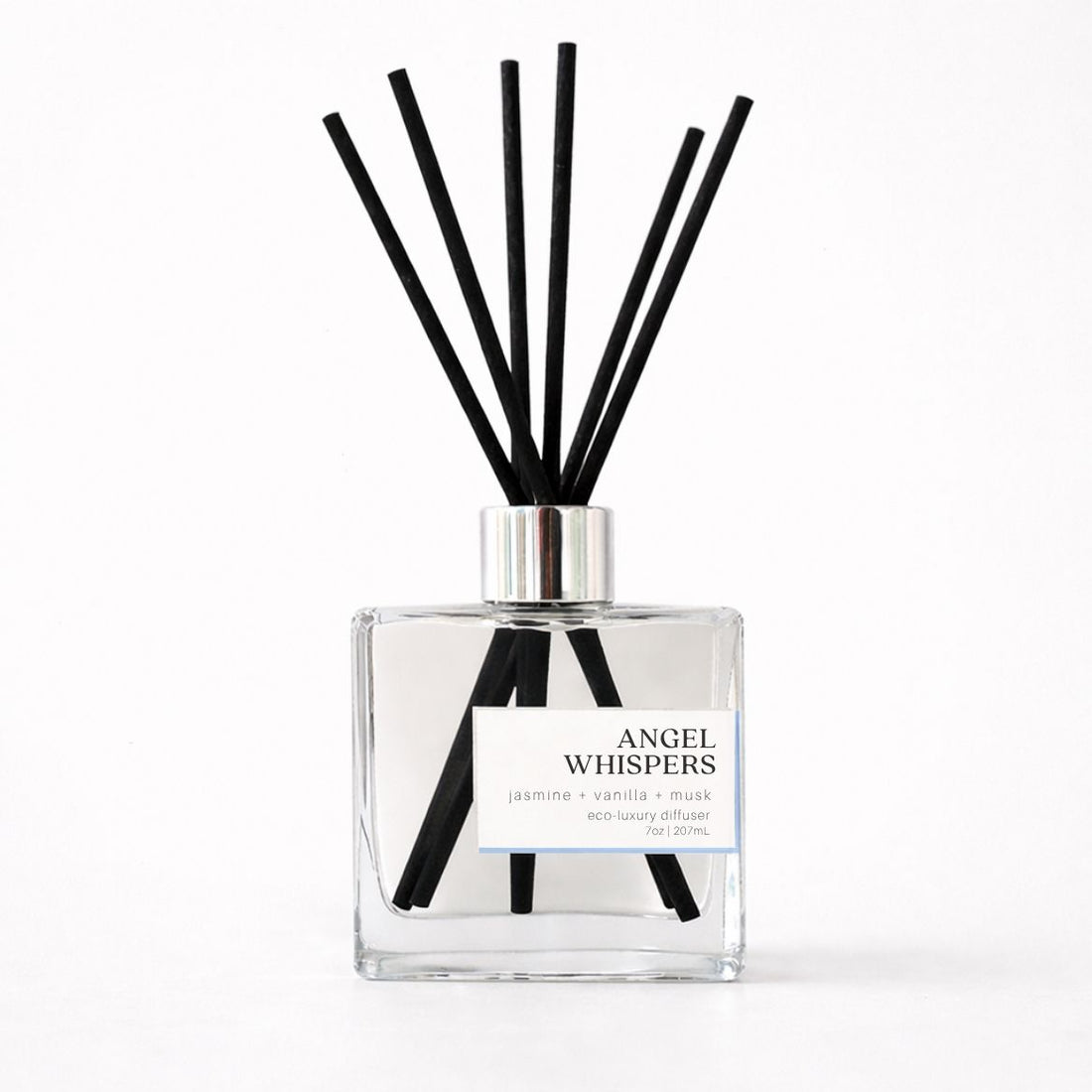 Clear diffuser bottle with black reeds labeled &