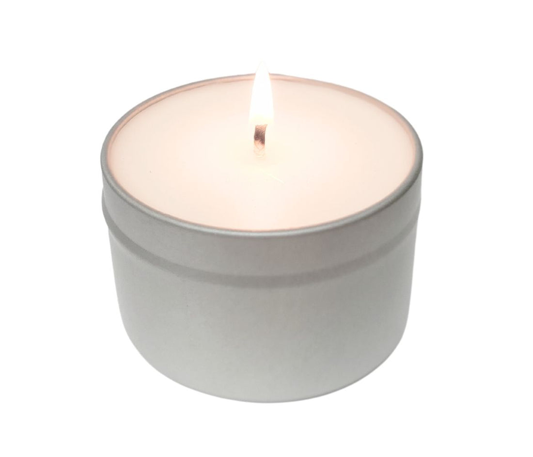 6oz tin candle made with coconut wax, burning softly to create a cozy ambiance.