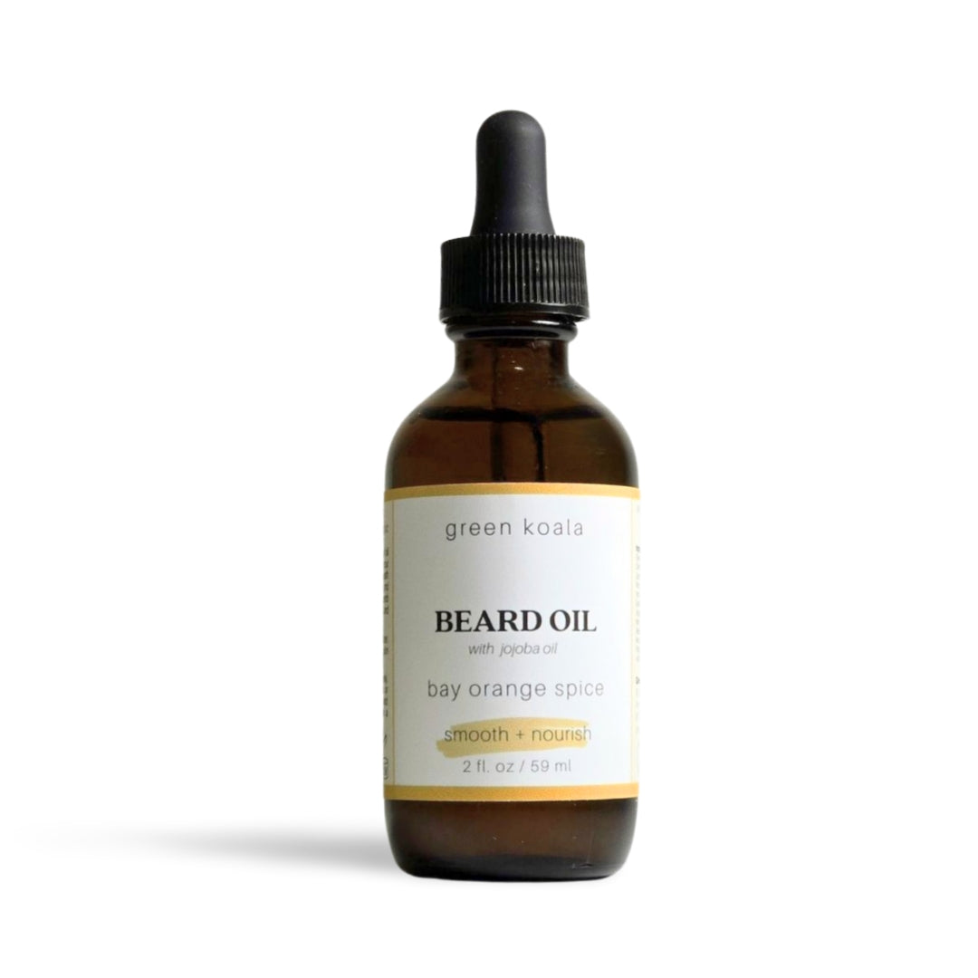 Green Koala Bay Orange Spice Beard Oil in an amber bottle with dropper with natural ingredients, providing a smooth and soft beard with a hint of orange and cinnamon scent.