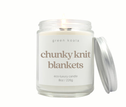 Green Koala Chunky Knit Blankets 8 oz. candle burning with lid to the side