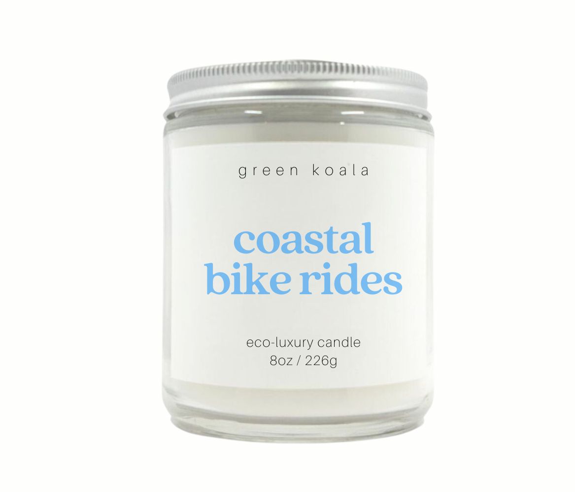 Coastal Bike Rides 8oz Candle with silver lid, featuring a serene coastal design, ideal for adding a relaxing vibe to any space. 