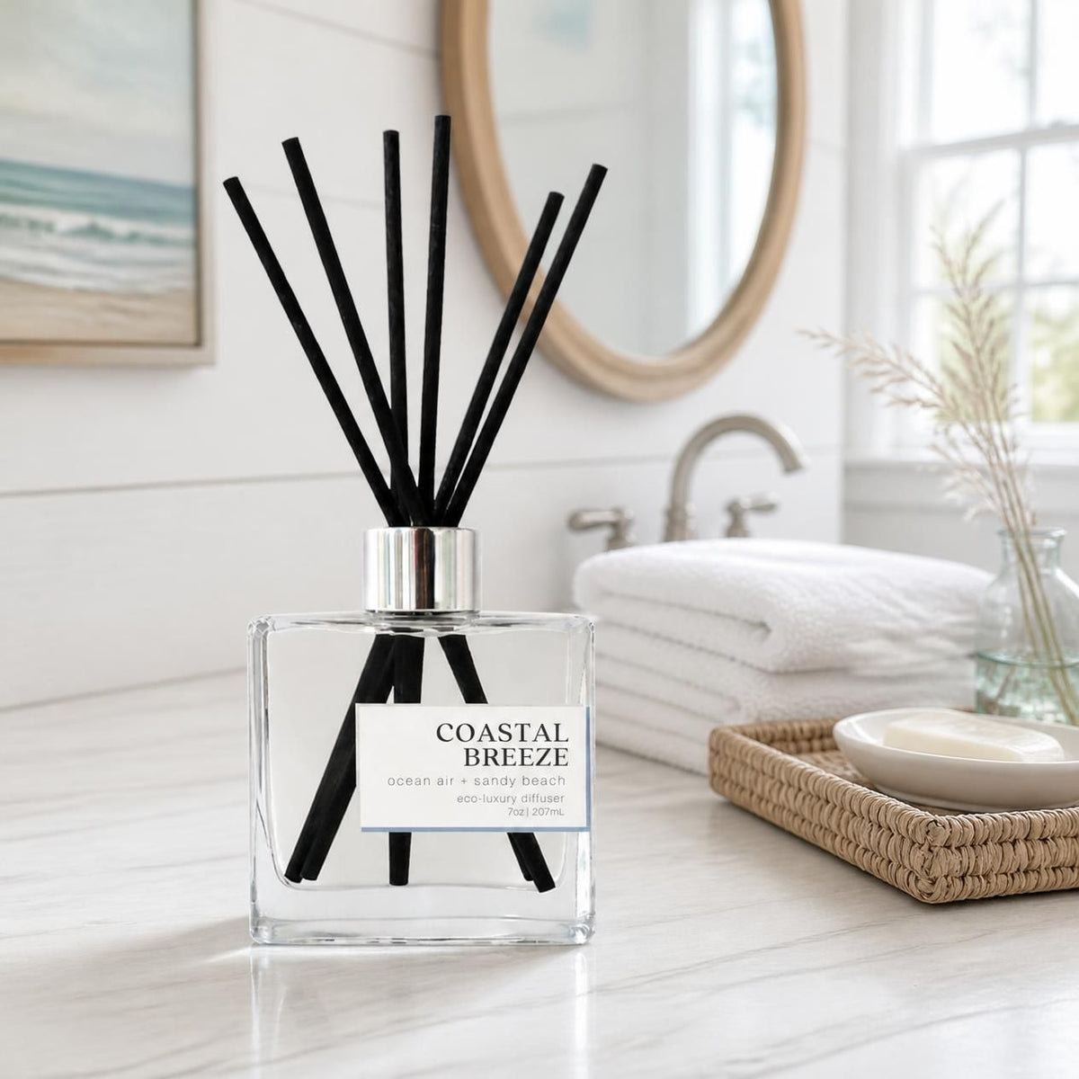 Green Koala Coastal Breeze non-toxic reed diffuser on a white coastal farmhouse bathroom vanity with white towels