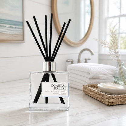 Green Koala Coastal Breeze non-toxic reed diffuser on a white coastal farmhouse bathroom vanity with white towels