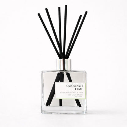 Green Koala Coconut Lime non-toxic reed diffuser with black fiber reeds on a white background
