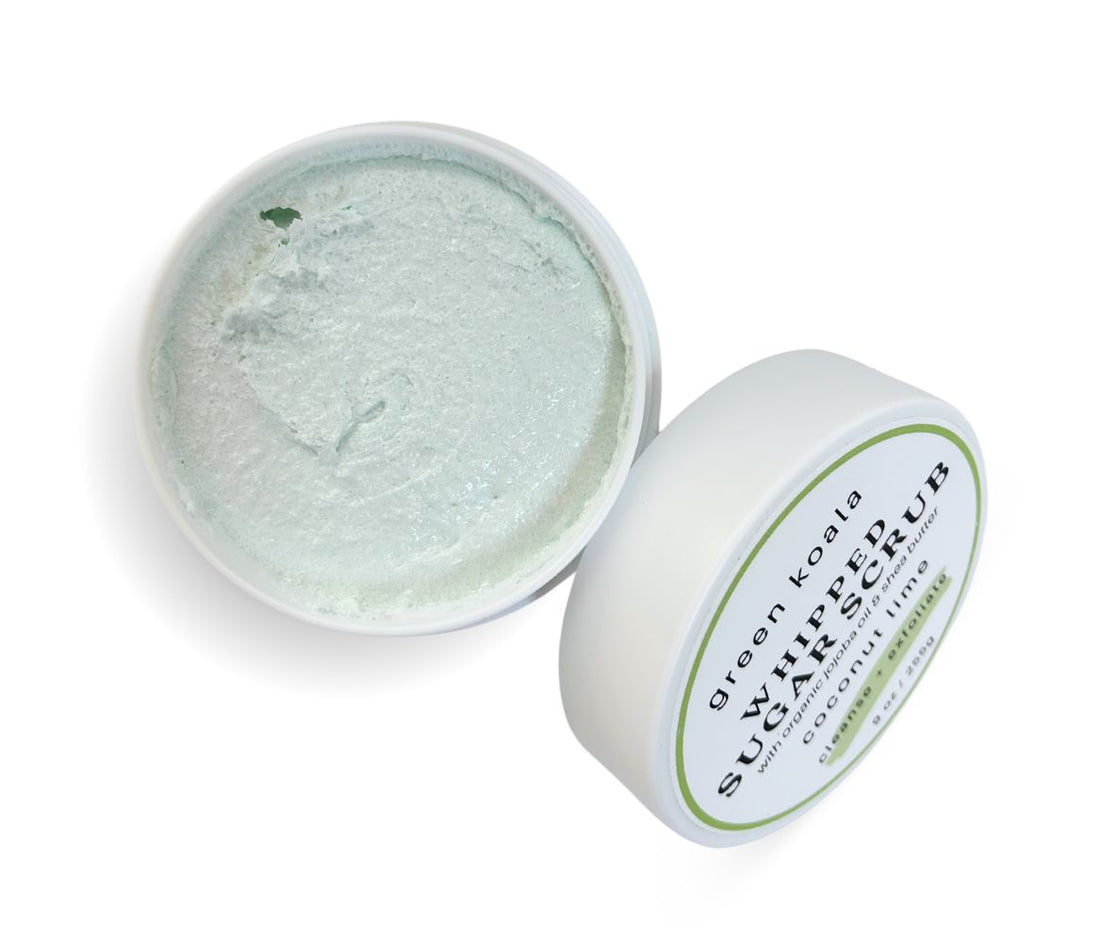 9oz Coconut Lime Sugar Scrub jar with lid leaning on side, showcasing whipped texture and tropical scent, cleanses, exfoliates and hydrates skin.
