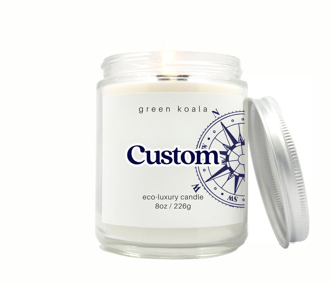 Custom candle in a clear 8oz jar with compass label design and place name. 