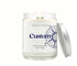 Custom candle in a clear 8oz jar with compass label design and place name. 