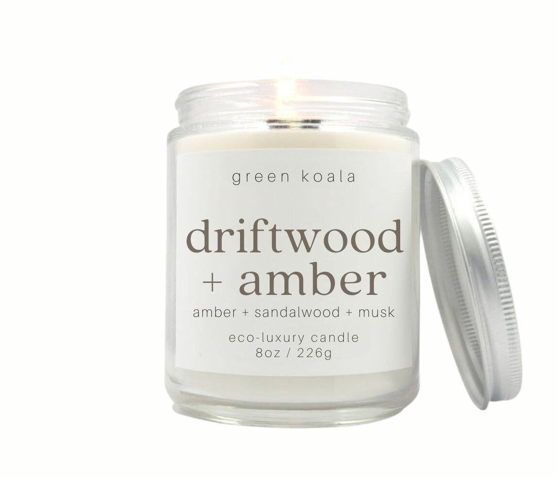 8oz Driftwood + Amber scented non-toxic and clean burning candle in a glass jar with silver lid.