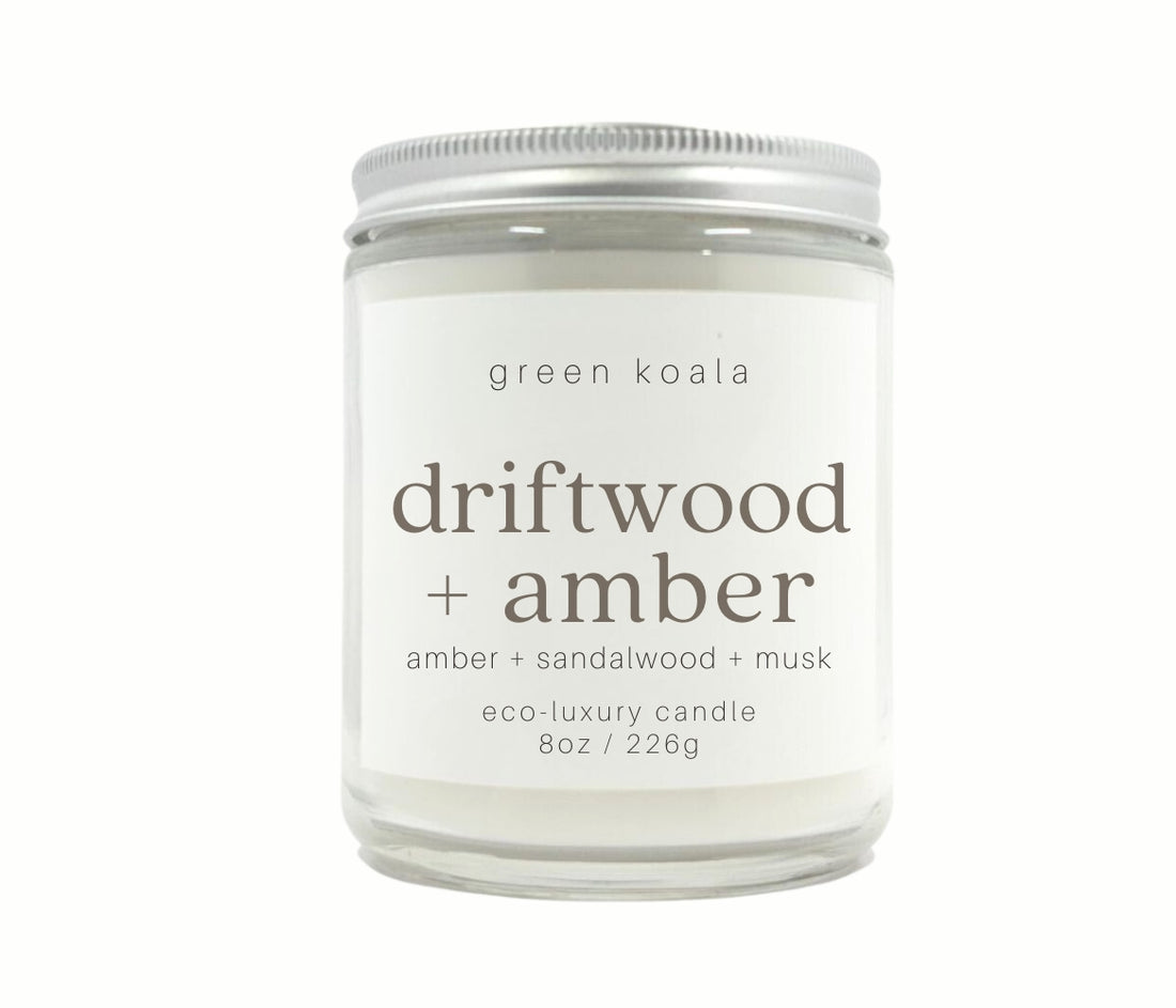 8oz Driftwood + Amber scented non-toxic hand poured candle in a glass jar with silver lid.