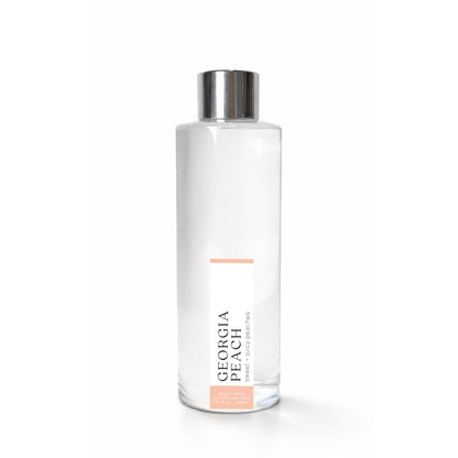 Clear bottle with silver cap on a white background, featuring &