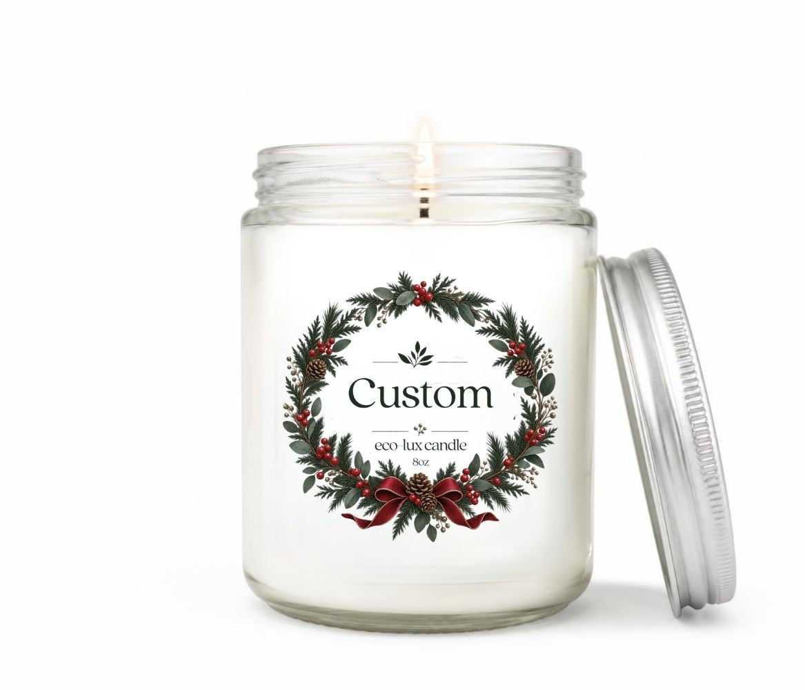 Personalized 8oz holiday candle in a clear glass jar with an evergreen wreath label, red berries and bow, silver lid leaning beside it