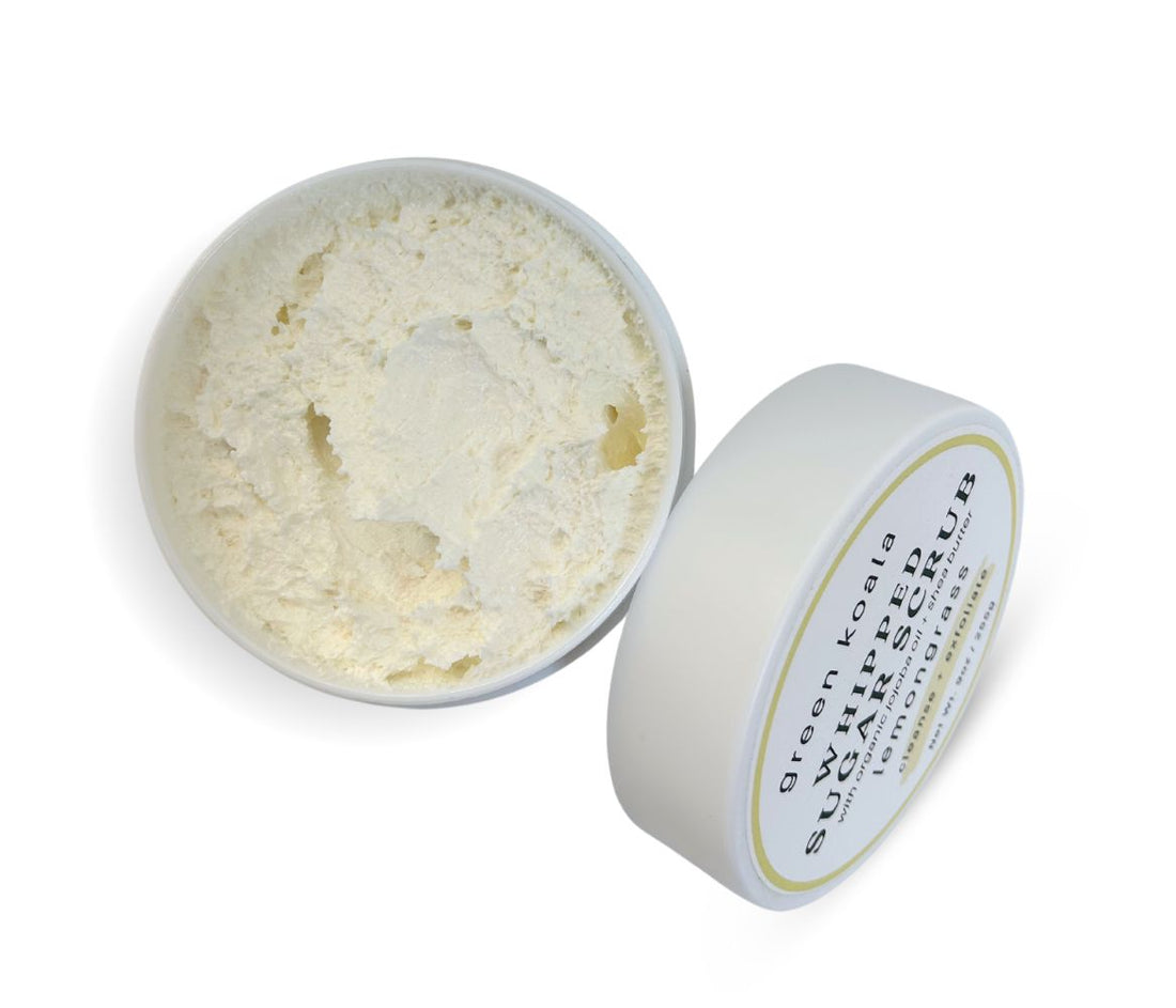 9oz Lemongrass Sugar Body Scrub jar with lid leaning on side, showcasing whipped texture and citrusy lemongrass scent, exfoliates and hydrates skin.