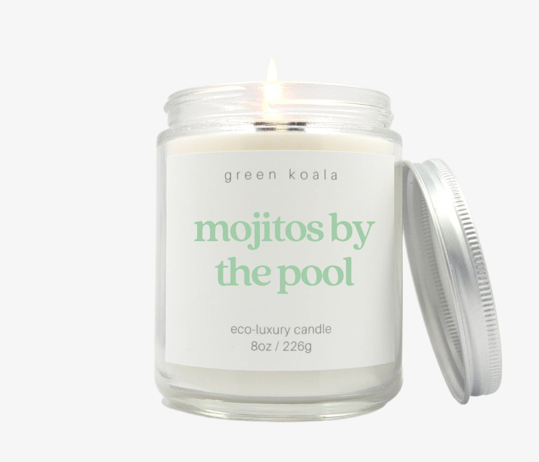 Mojitos by the pool scented candle in an 8oz glass jar with silver lid. Made with coconut wax. Photo is a burning candle.