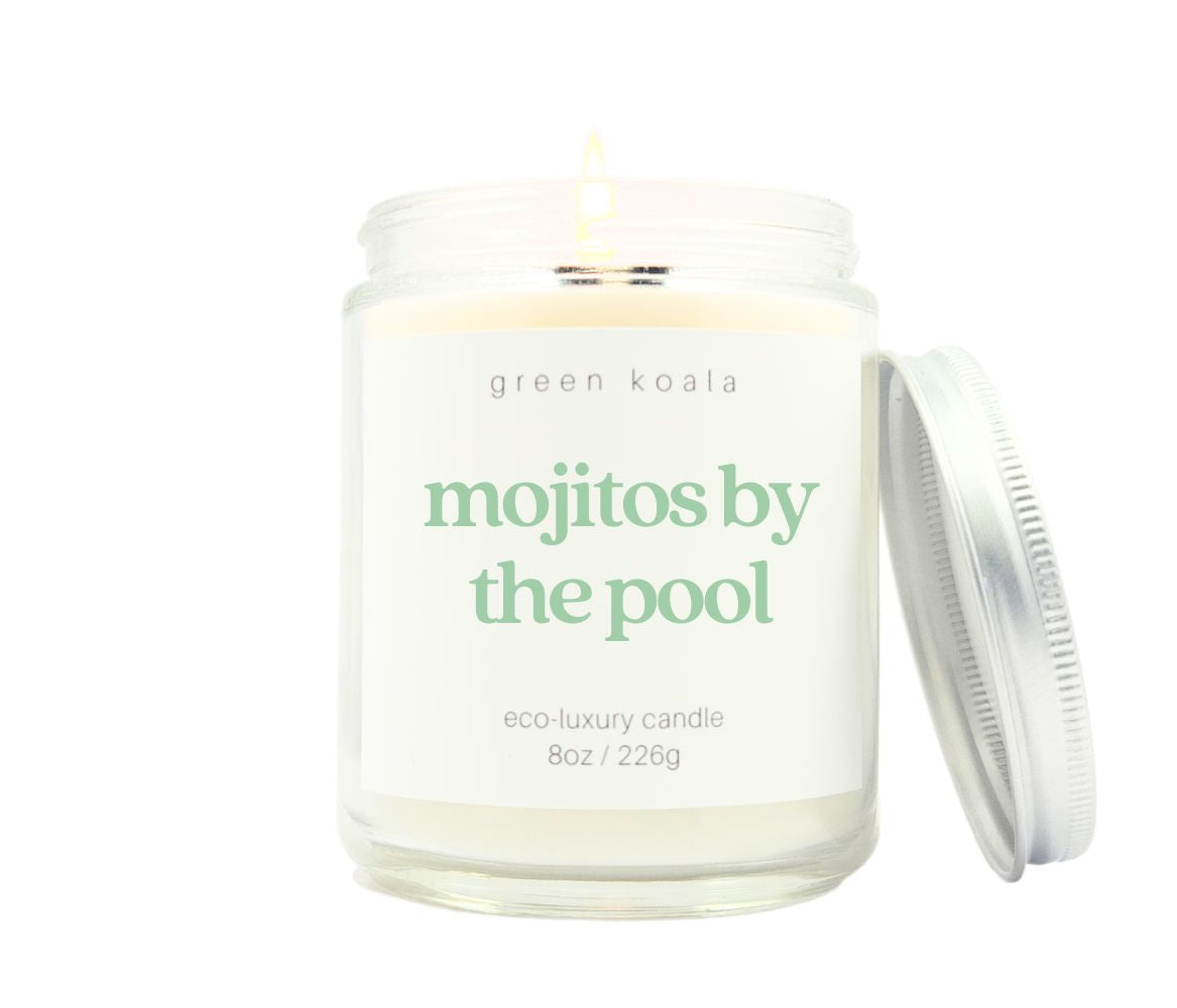 Mojitos by the pool scented candle in an 8oz glass jar with silver lid. Made with coconut wax. Photo is a burning candle.