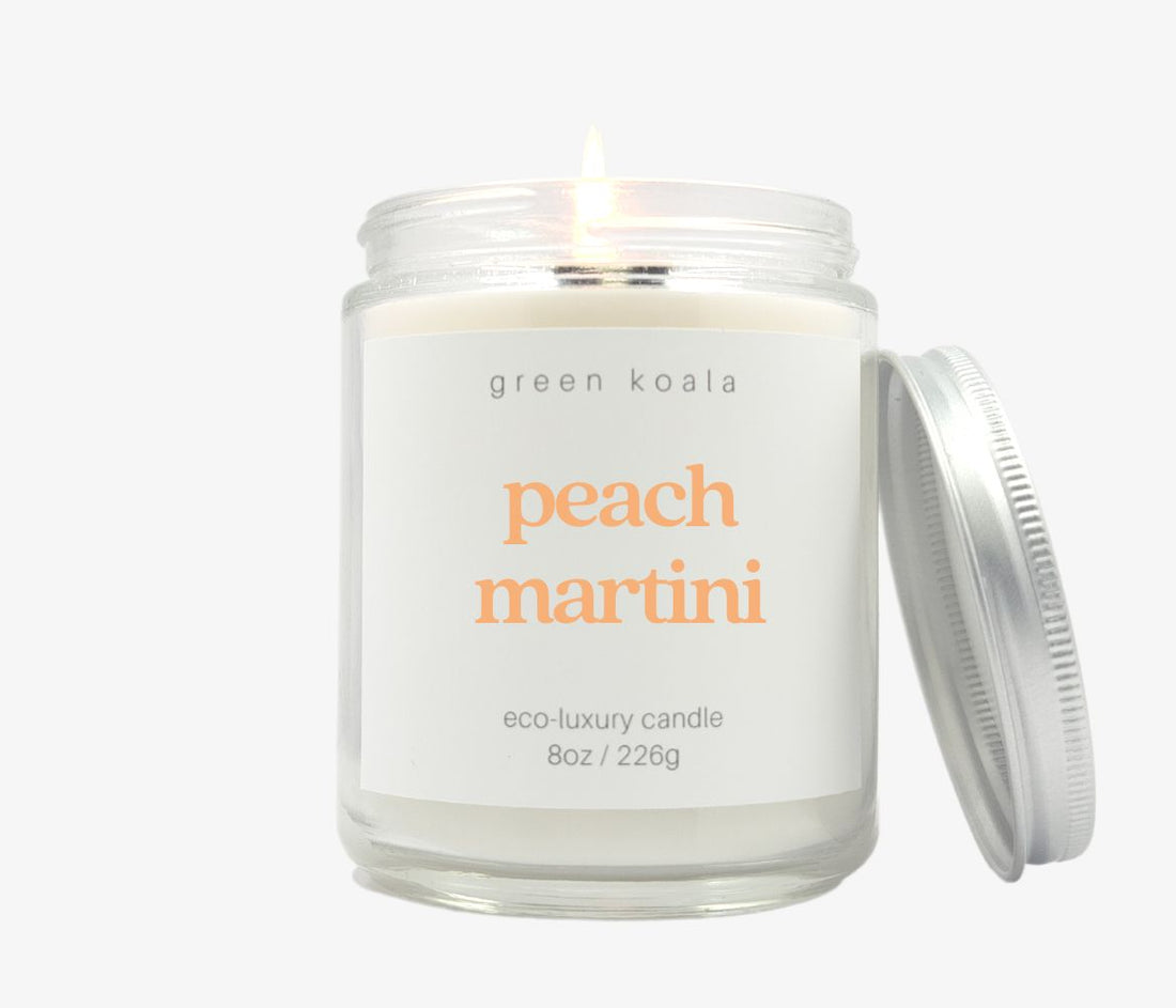 8oz peach martini scented candle in a glass jar with silver lid made with coconut wax.