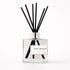 Pink Orchid diffuser with black reeds on a white background