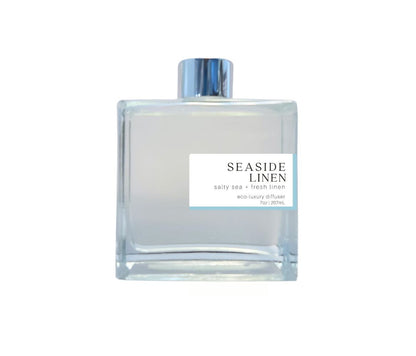 Seaside Linen 7oz non-toxic scented reed diffuser in glass jar.