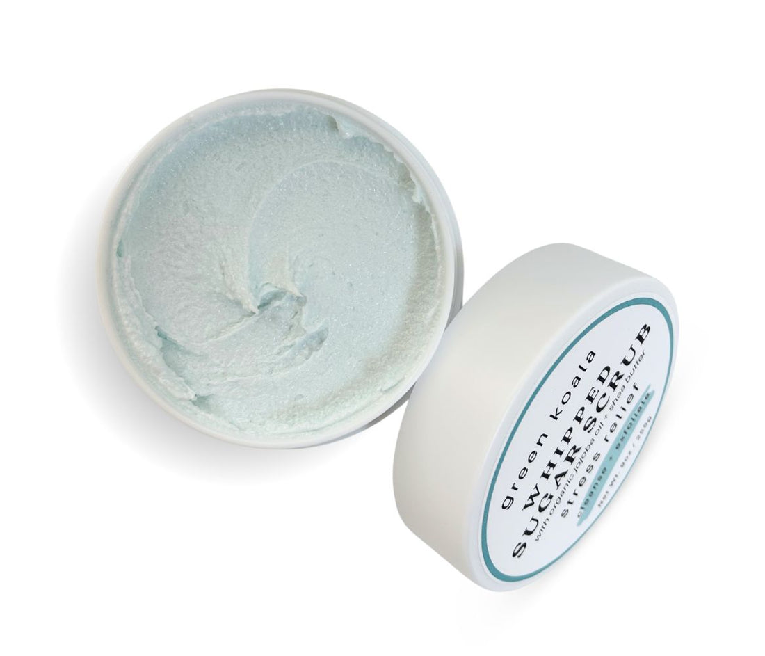 9oz Stress Relief Body Scrub jar with lid leaning on side, showcasing whipped texture and soothing herbal-minty aroma, cleanses, exfoliates, and deeply hydrates skin.